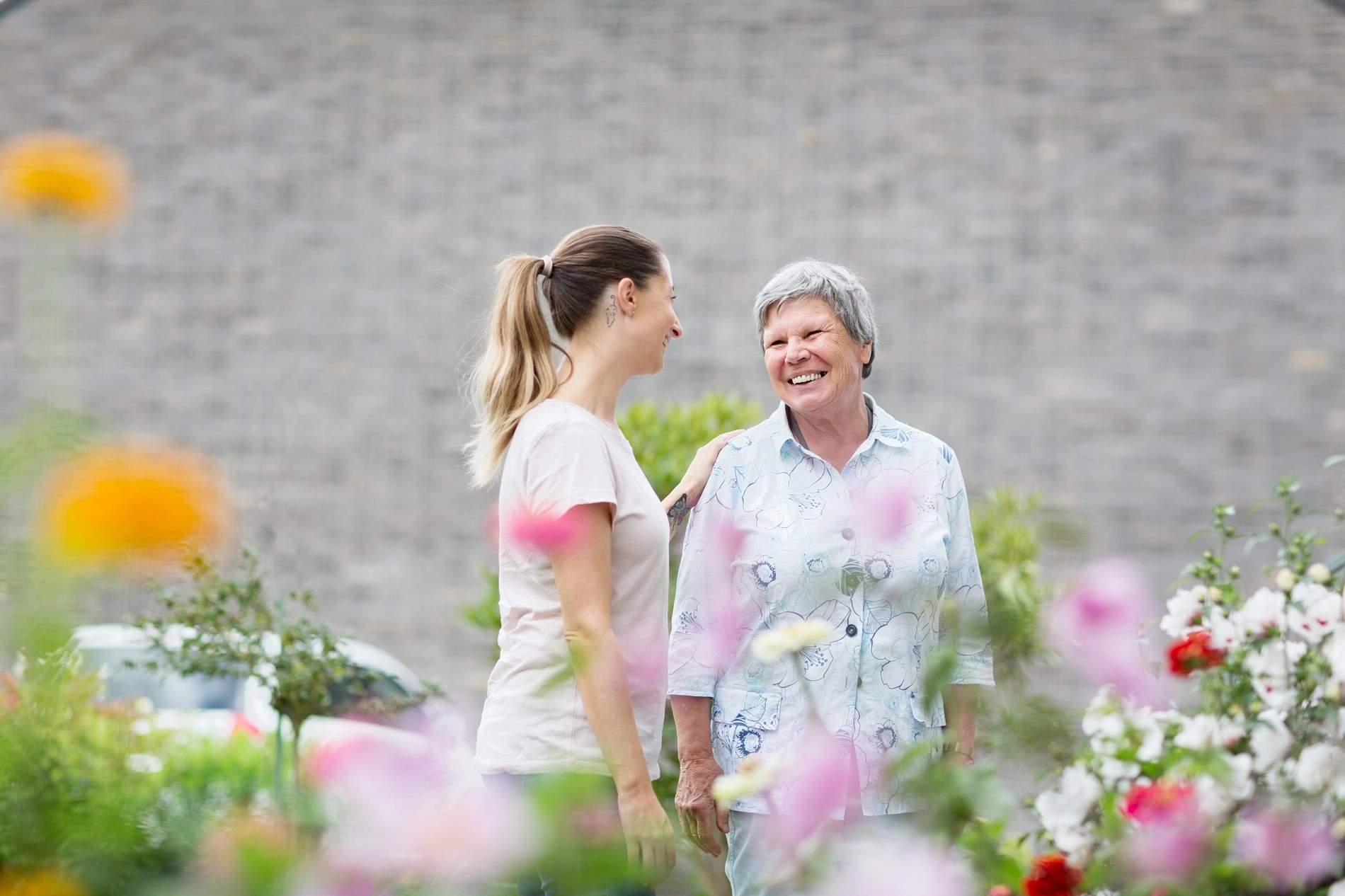 Professional caregiver walking with elderly clients outdoors in Atlanta Georgia