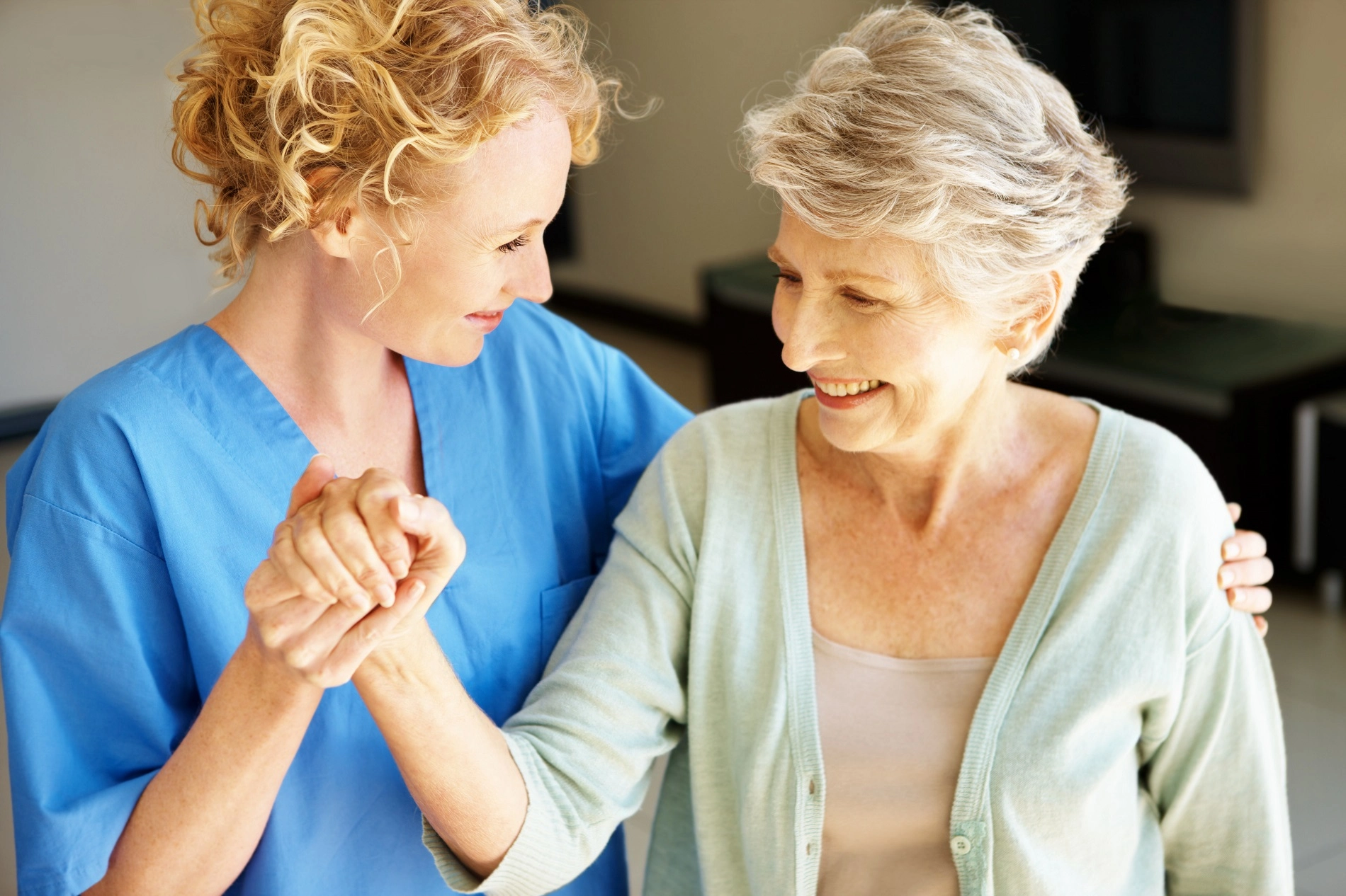 Caregiver providing adult care services to elderly client at home in Atlanta Georgia